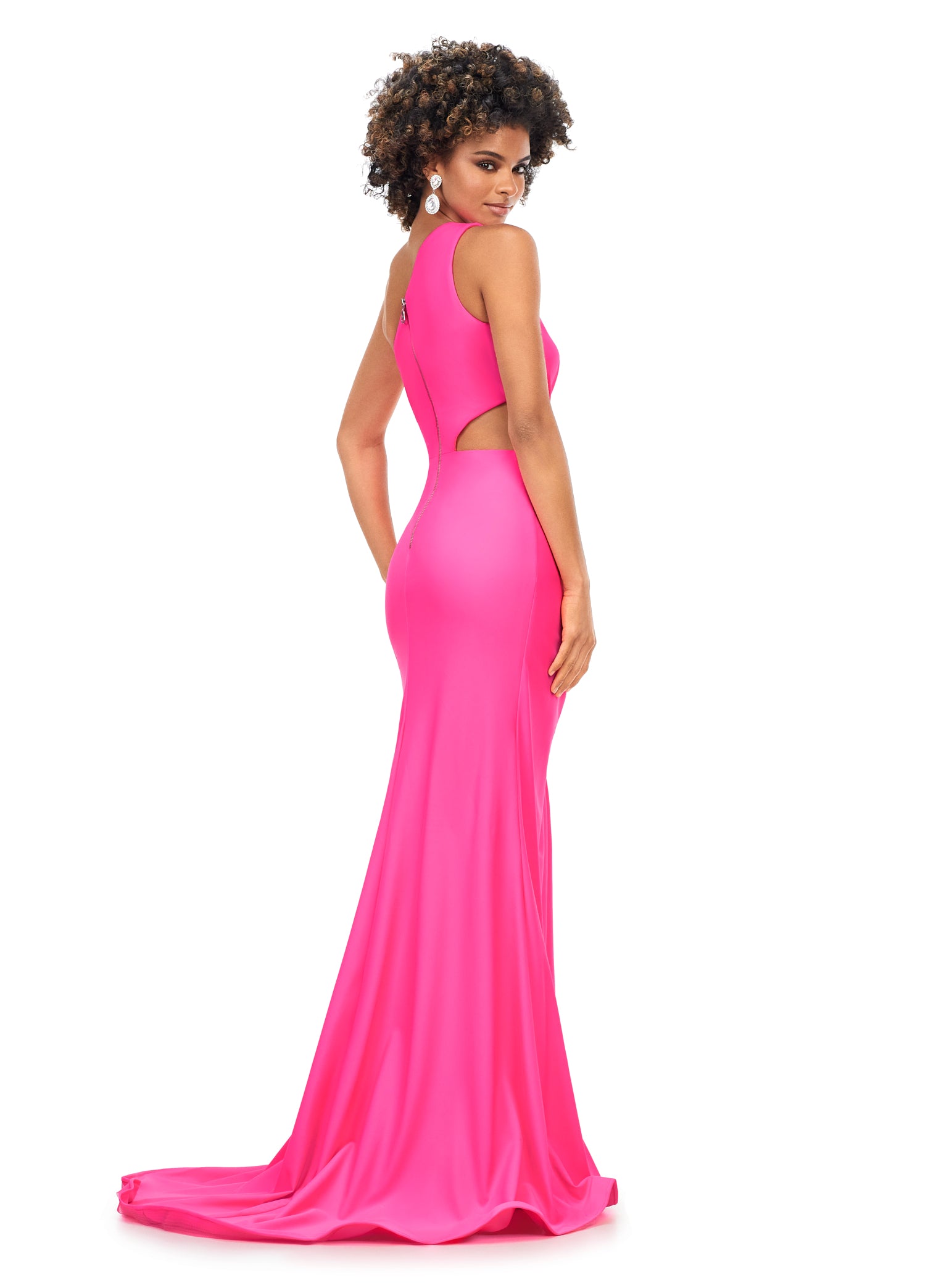 Ashley Lauren 11303 This one shoulder jersey gown features a ruched bodice with asymmetrical cut outs. The ruching continues onto the fitted skirt with slit. The look is complete with an exposed metal zipper back.