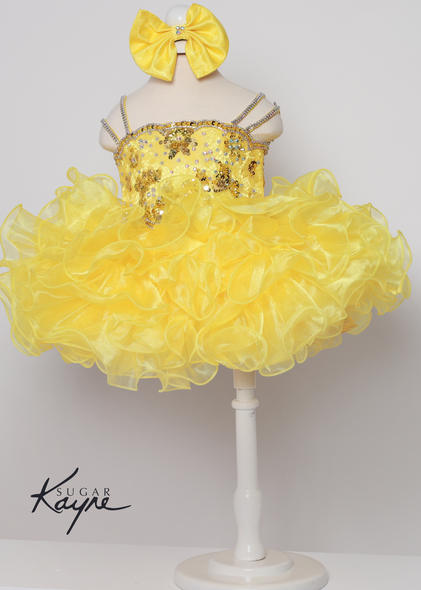 Sugar Kayne C225 Girls Baby Lace Sequin Crystal Cupcake Pageant Dress Ruffle Skirt Bow Corset.. Have your little cupcake bring on all the charm in this stunning organza and stretch lace gown. The corset back is the perfect addition as the little one grows! Colors: Barbie Pink, Royal, Yellow, White Sizes: 0M, 12M, 18M, 24M, 2T, 3T, 4T, 5T, 6M, 6T Fabric Organza, Stretch Lace, Satin Lining