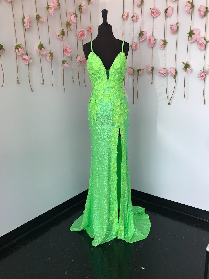 Jovani 1012 is a Delicate all over sequin Embellished Prom Dress with Floral Appliques. Features a plunging neckline & Slit in the skirt. Small Train in Back. Details: Sequin fabric, floral appliques, fitted silhouette, high slit skirt with sweeping train, sleeveless bodice, plunging neckline with sheer mesh insert, low back with strap across for support, spaghetti straps over shoulders.