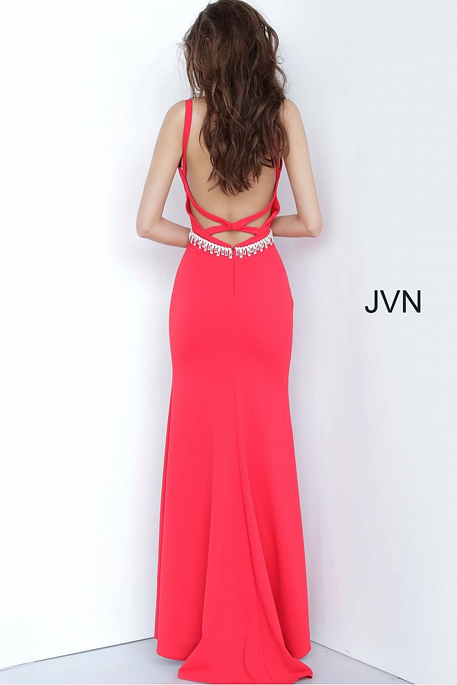 JVN by Jovani 02712 is a long Fitted Low Cut V neck Prom, Pageant & Formal evening wear dress. Long Fitted gown with an embellished tassel crystal waist belt. Open criss cross back. Stunning classic gown. fitted bodice with slightly flared skirt featuring a slit.