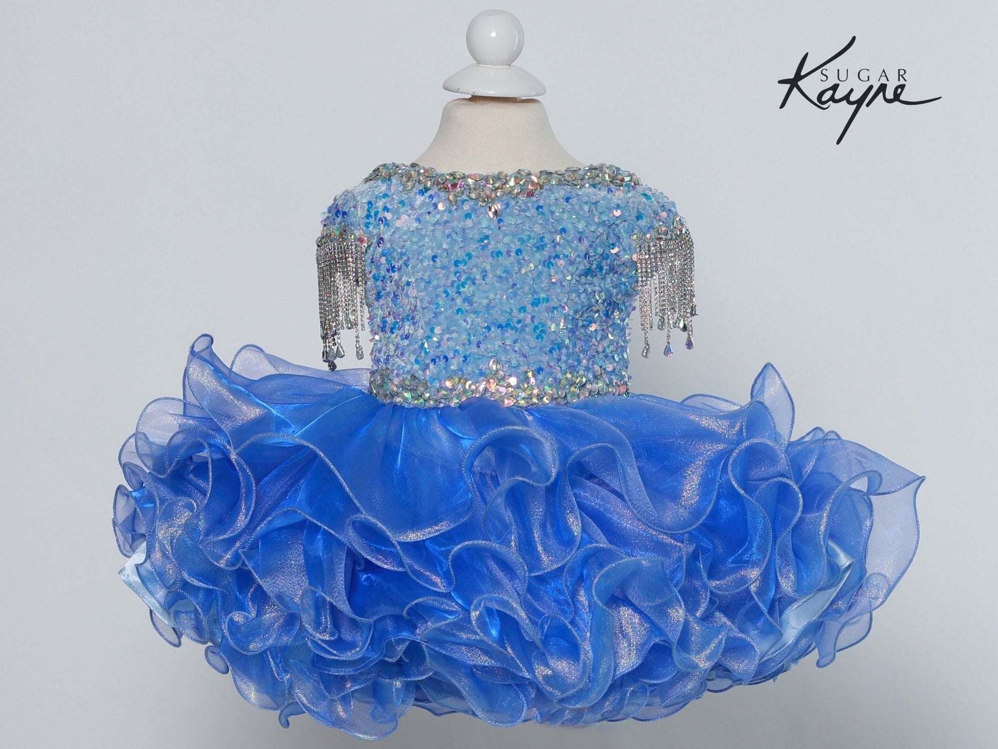 Sugar Kayne C203 Short Girls Cupcake Velvet Sequin Pageant Dress Crystal Fringe Tassel Cap Sleeve corset back  Sizes: 0M, 6M, 12M, 18M, 24M, 2T, 3T, 4T, 5T, 6T  Colors: Cotton Candy, Powder Blue, Unicorn