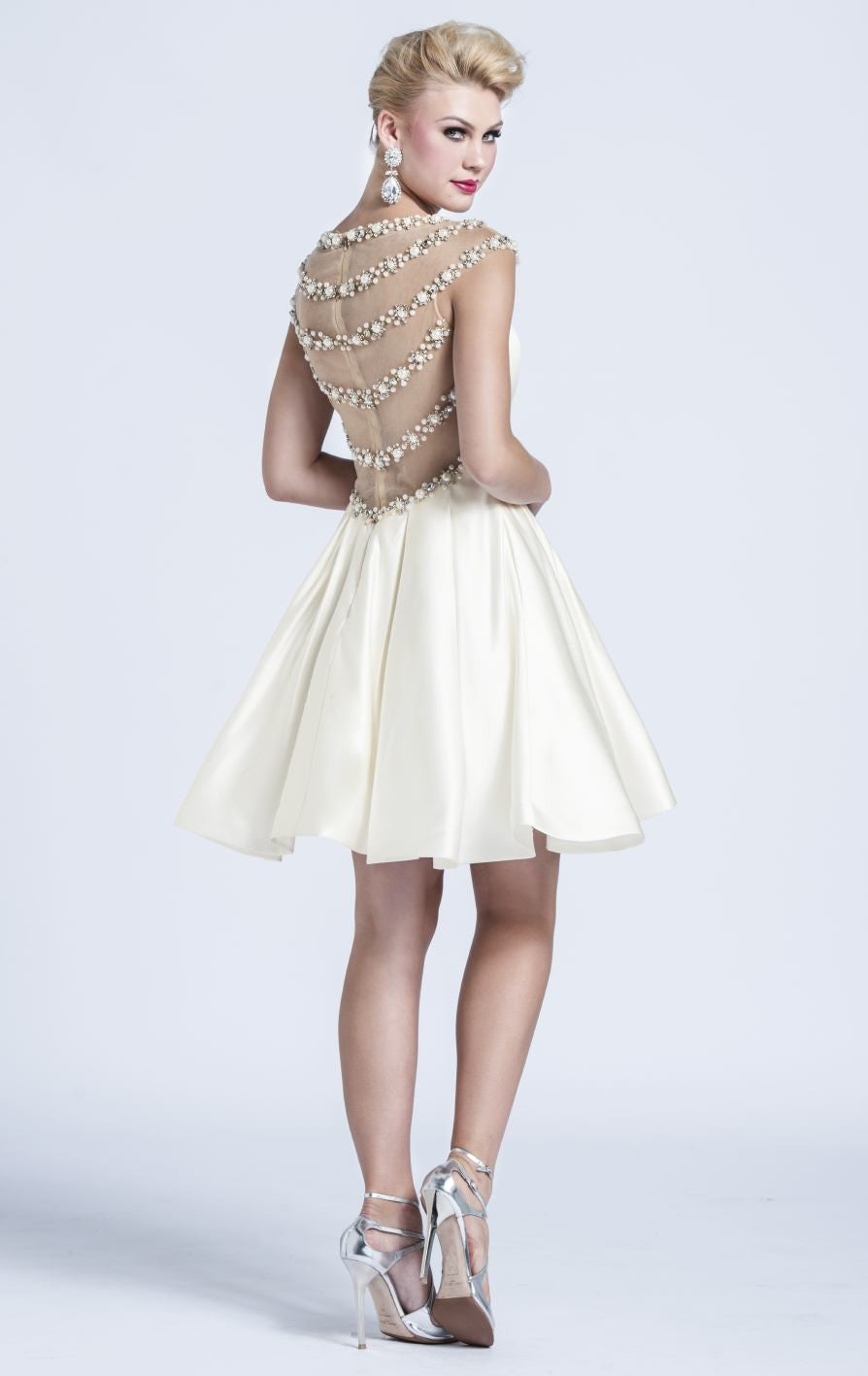 Ashley Lauren 4027 is a Gorgeous Short Fit & Flare Formal Cocktail Dress. Featuring a sheer illusion sweetheart neckline with a fitted satin bodice and sheer side cutouts. This Gown Features rows of Heavily Embellished Crystals, Pearl accents & More! Over the top Glam Style is great for Pageants, Prom & More! Available Sizes: 4 Available Colors: Turquoise, Black, Fuchsia, Ivory Glass Slipper Formals Lake City Florida