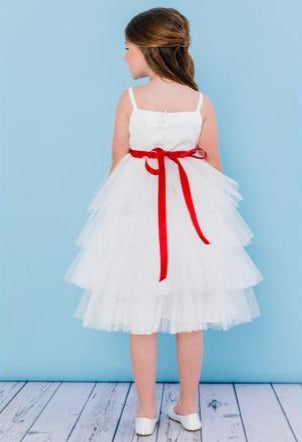 Rosebud Fashions Style 5117 is a spaghetti strap T-length dress. The bodice is satin with a 4 tiered tulle skirt that is accented with a ribbon that ties in the back with a flower. Satin buttons cover the zipper. Great flower girl dress & Formal Party Gown! Available Sizes: 2,4,6,8,10,12 Available Colors: White, Ivory Fabric is Satin and Tulle