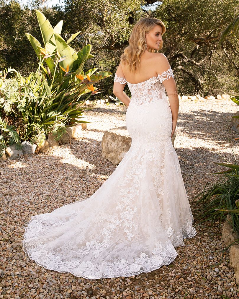 Style 2376 KARINA by Casablanca Bridal is a glamorous twist on the classic lace wedding dress. Off-shoulder sleeves transition into a classic sweetheart neckline, while floral lace swirls all throughout the fit-and-flare silhouette. The illusion back, lined with a row of subtle crystal buttons, transitions flawlessly into a gently scalloped train. A matching, two-tier cathedral length veil is available for the bride who wants to make an extra remarkable impact. Size: 10, 14, 20 Ivory/Nude/Ivory/Silver