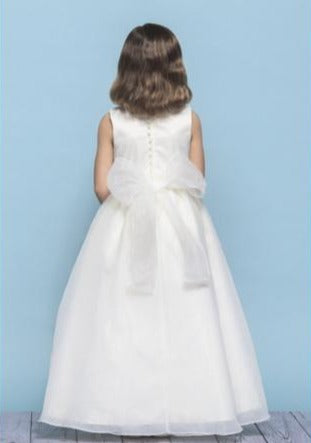 Rosebud Fashions Style 5105 is a sleeveless dress with a scoop neckline. Delicate pearls trim the natural waist and neckline. Self tying organza streamers tie into an organza bow in the back. Satin buttons cover the zipper. Rosebuds Satin And Organza Available Sizes: 2,4,6,8,10,12 Available Colors: Ivory, White Fabric: Satin and Organza