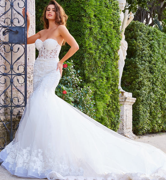 Jovani Bridal JB07260 Sheer Corset Lace Mermaid Wedding Dress Bridal Gown Train Strapless This Jovani JB07260 off white wedding dress is styled in soft tulle with floral appliques, featuring a sheer corset bodice with a strapless sweetheart neckline. Lush godets form this trumpet-style bridal gown, finished with a lace border hemline and a semi-cathedral train. Available Sizes: 00-24 Available Colors: Off White