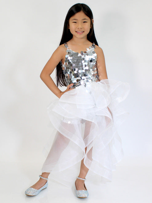 Marc Defang 5002 High Low Sequin Girls Pageant Romper Layered Detachable Overskirt Fun fashion romper Detachable Overskirt (Price inclusive of the overskirt) Large circle shape beads, Fully beaded romper Ruffled detachable skirt Center back invisible zipper Lined top Available Sizes: 4-14 Available Colors: Silver