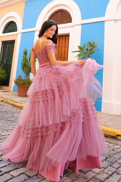 Experience the elegance and sophistication of the Nox Anabel E1293 Prom Dress. With a stunning A-line silhouette, pleated tulle layers, and sheer lace embellished Corset , this dress will make heads turn. Complete with an off-shoulder design and a delicate bow, this dress is perfect for a prom or any formal event.  Sizes: 0-16  Colors: Blue, Mauve, Mint Green, Periwinkle