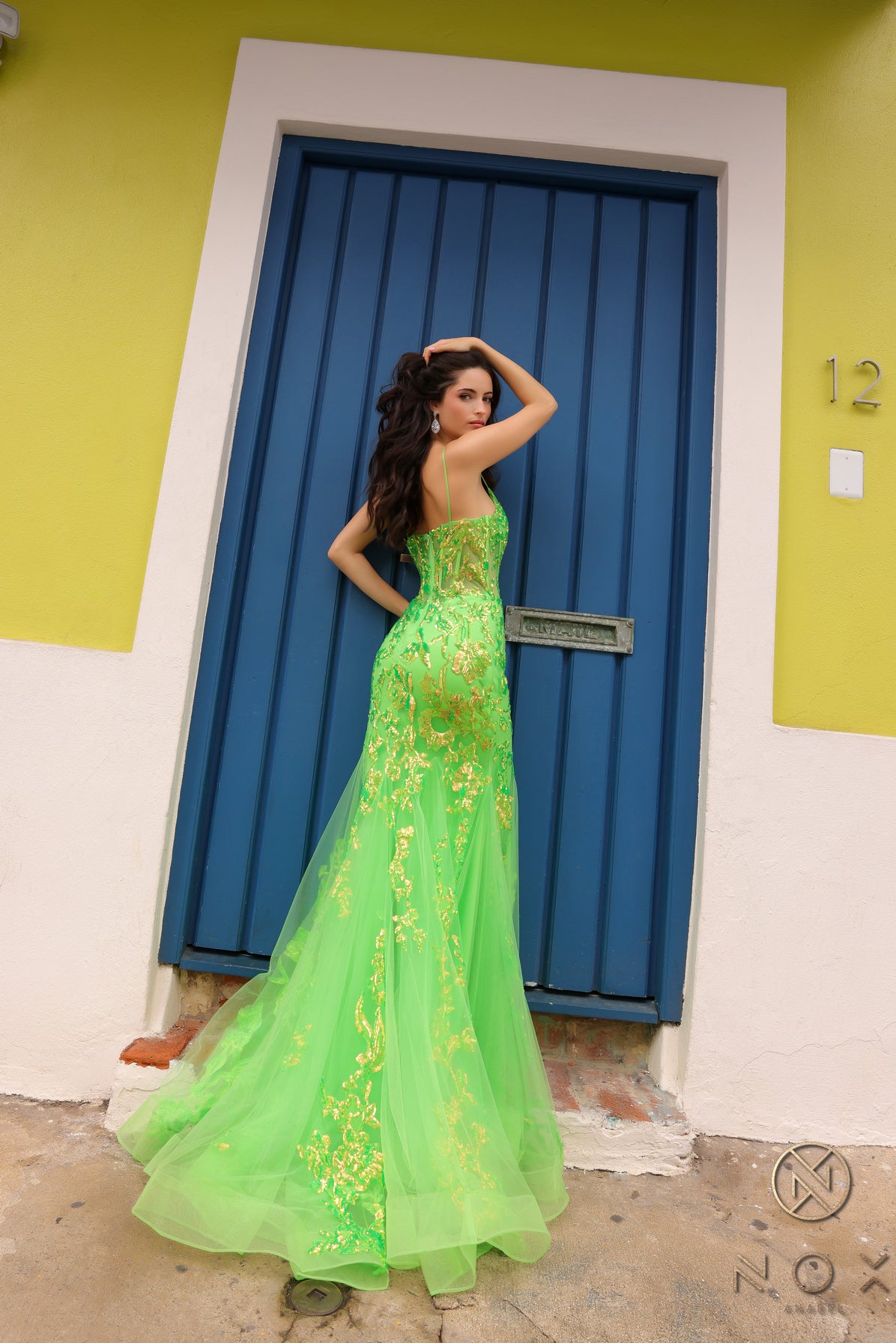 Elevate your prom or pageant look with the Nox Anabel Q1390 Prom Dress. Featuring a long sequin body with a sheer corset and mermaid silhouette, this dress will have you shining all night. Stand out in vibrant neon while feeling confident and elegant.  Sizes: 0-16  Colors: Neon Green, Neon Orange, Coral Fuchsia, Ocean Blue