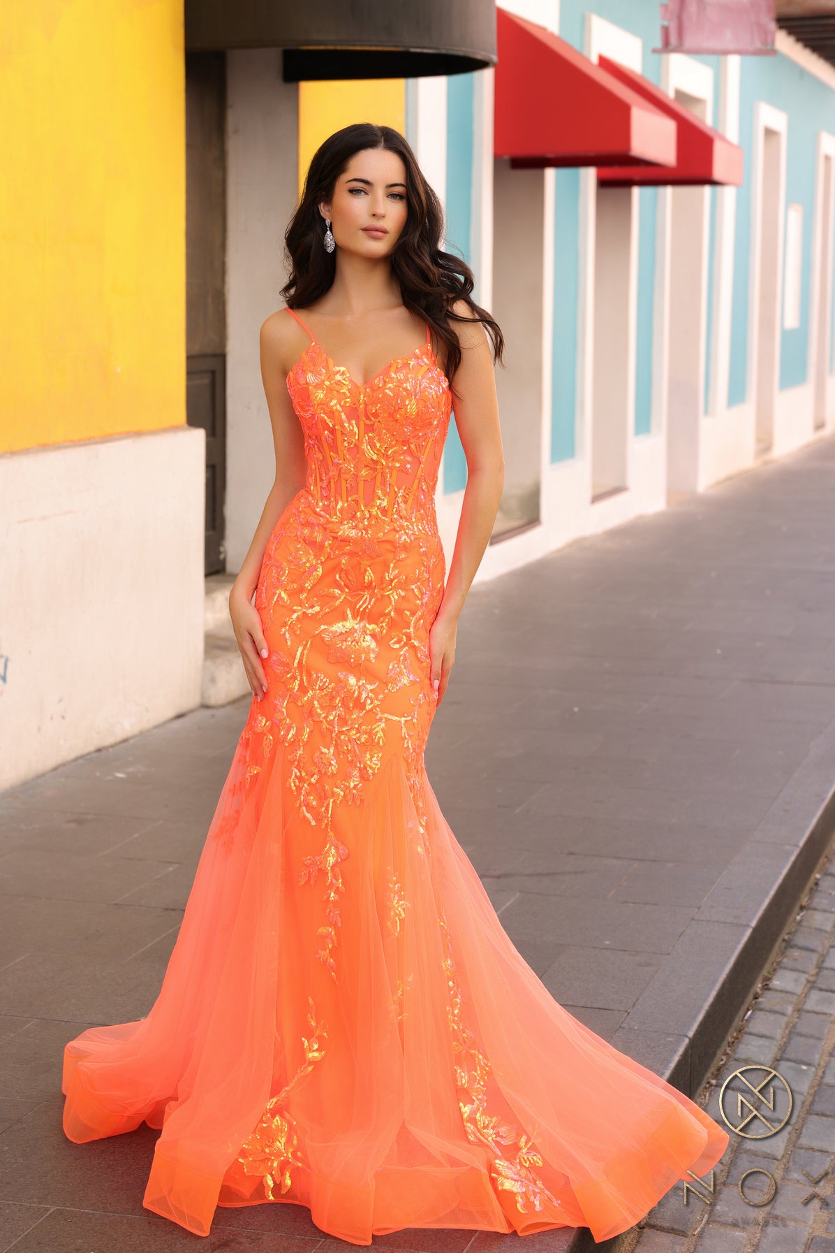 Elevate your prom or pageant look with the Nox Anabel Q1390 Prom Dress. Featuring a long sequin body with a sheer corset and mermaid silhouette, this dress will have you shining all night. Stand out in vibrant neon while feeling confident and elegant.  Sizes: 0-16  Colors: Neon Green, Neon Orange, Coral Fuchsia, Ocean Blue