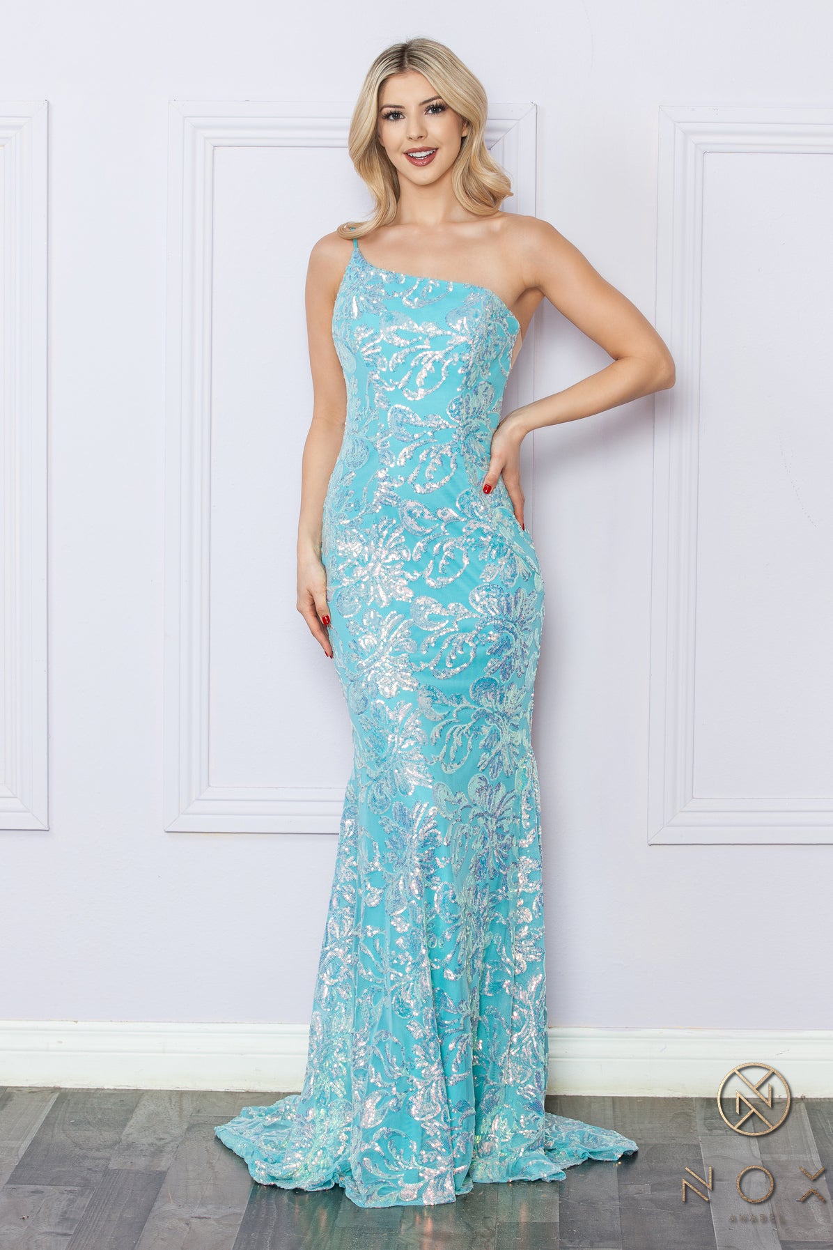 Be the ultimate showstopper in this stunning Nox Anabel R1308 sequin lace one shoulder prom dress. The mermaid silhouette and formal design will give you the confidence to shine on any pageant stage. Guaranteed to make a lasting impression, this gown is a must-have for any special occasion.  Size: 0-16  Colors: Fuchsia, Aqua Blue, White Multi