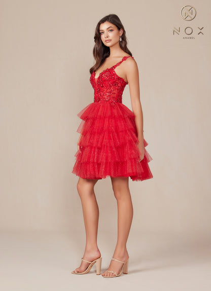 Experience glamour and elegance in our Nox Anabel E904 Dress. Featuring sheer lace and sequin detailing, this short dress is perfect for any homecoming event. The layered shimmer skirt adds dimension and the corset gown ensures a perfect fit. Make a statement with this stunning piece.