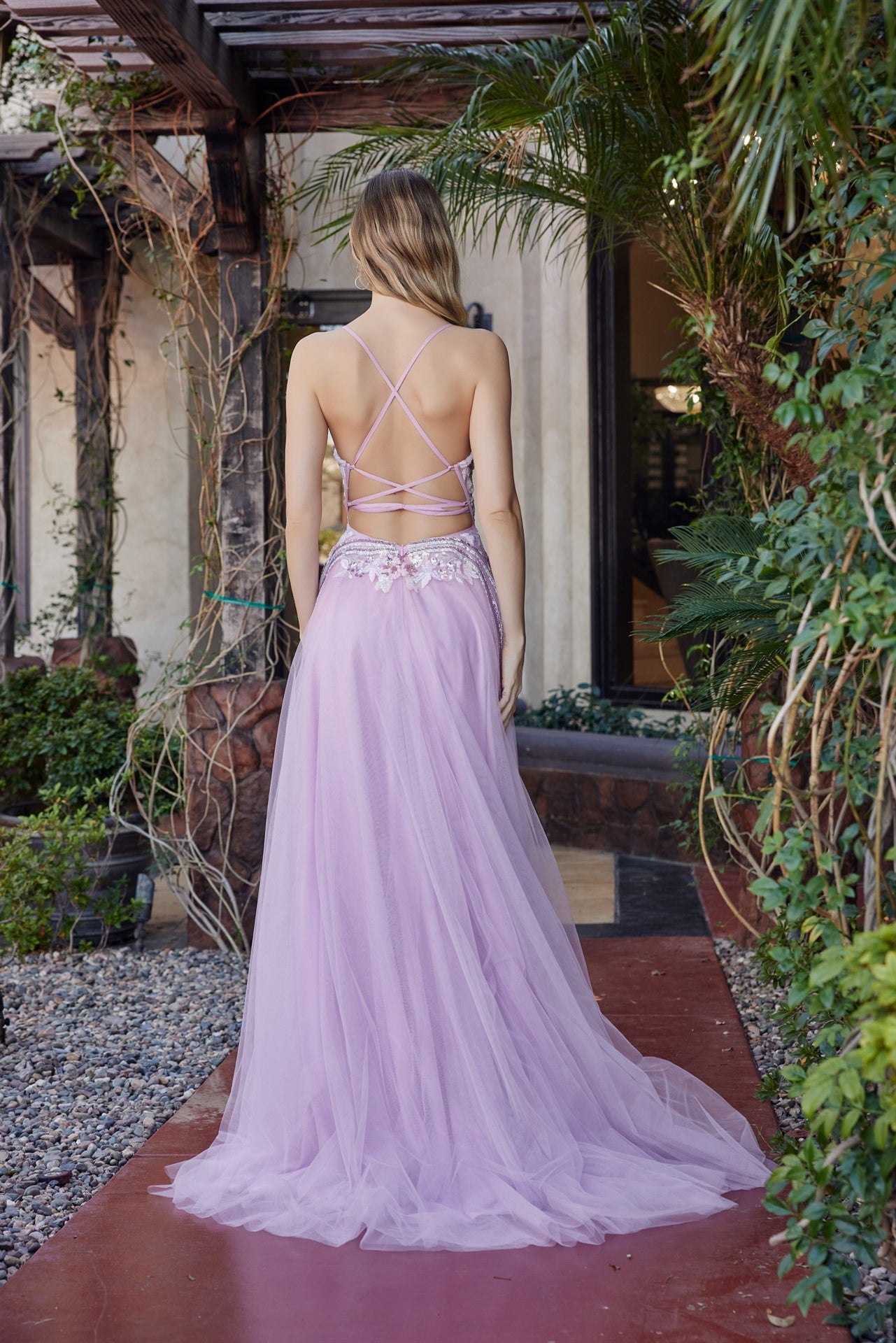 Nox Anabel's G1795 prom dress commands attention with its daring plunging V-neckline and sheer sequin corset bodice that catches light from every angle. Delicate spaghetti straps frame the shoulders while the backless design creates an elegant, modern silhouette. A graceful train adds dramatic movement and sophistication to your entrance. Perfect for prom, formal galas, or black-tie events where you want to make a memorable impression. This statement piece combines intricate beading with refined tailoring f