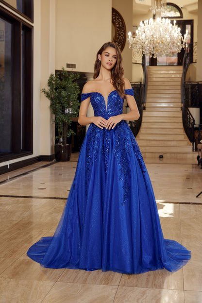 Nox Anabel's H1881 prom dress combines timeless elegance with contemporary allure. The off-the-shoulder silhouette frames the shoulders beautifully, while the sheer corset bodice creates a striking focal point with its plunging V-neckline. The flowing A-line skirt transitions into a graceful train, offering movement and drama on the dance floor. Crafted for those seeking a show-stopping entrance at prom or formal events, this dress balances sophistication with bold design details.

Sizes: 00-16

Colors: Aqu