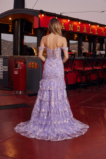 Nox Anabel's G1916 is a show-stopping prom dress designed for those who want to make an unforgettable entrance. This mermaid silhouette features a sheer sequin floral corset bodice that catches light with every movement, paired with an elegant off-the-shoulder neckline and plunging sweetheart cut. Dramatic ruffle detailing adorns the voluminous train, while a thigh-high slit adds modern sophistication and ease of movement. Perfect for prom, formal galas, or any black-tie event where you want to command atte