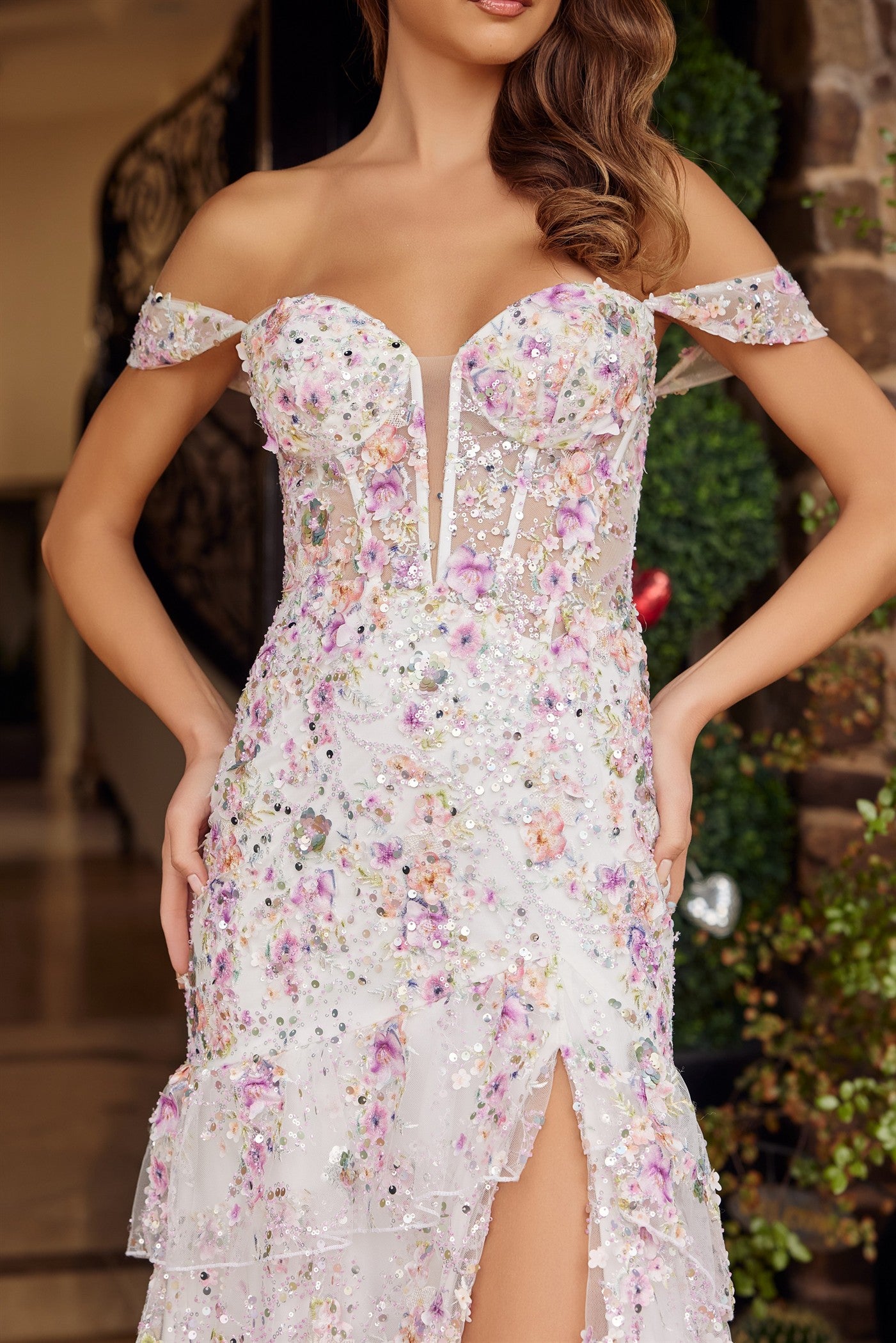 Nox Anabel's G1916 is a show-stopping prom dress designed for those who want to make an unforgettable entrance. This mermaid silhouette features a sheer sequin floral corset bodice that catches light with every movement, paired with an elegant off-the-shoulder neckline and plunging sweetheart cut. Dramatic ruffle detailing adorns the voluminous train, while a thigh-high slit adds modern sophistication and ease of movement. Perfect for prom, formal galas, or any black-tie event where you want to command atte