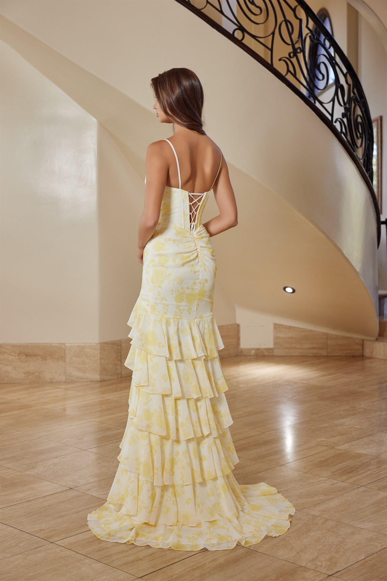 Nox Anabel's T1863 prom dress combines timeless elegance with modern glamour. The sweetheart neckline and structured corset bodice create a flattering silhouette, while delicate sequins catch the light with every movement. Dramatic ruffles add dimension and romance, enhanced by a striking floral print that sets this gown apart. Spaghetti straps offer refined support, and the flowing train with thigh-high slit delivers both sophistication and freedom of movement. Perfect for prom, formal galas, or any occasi