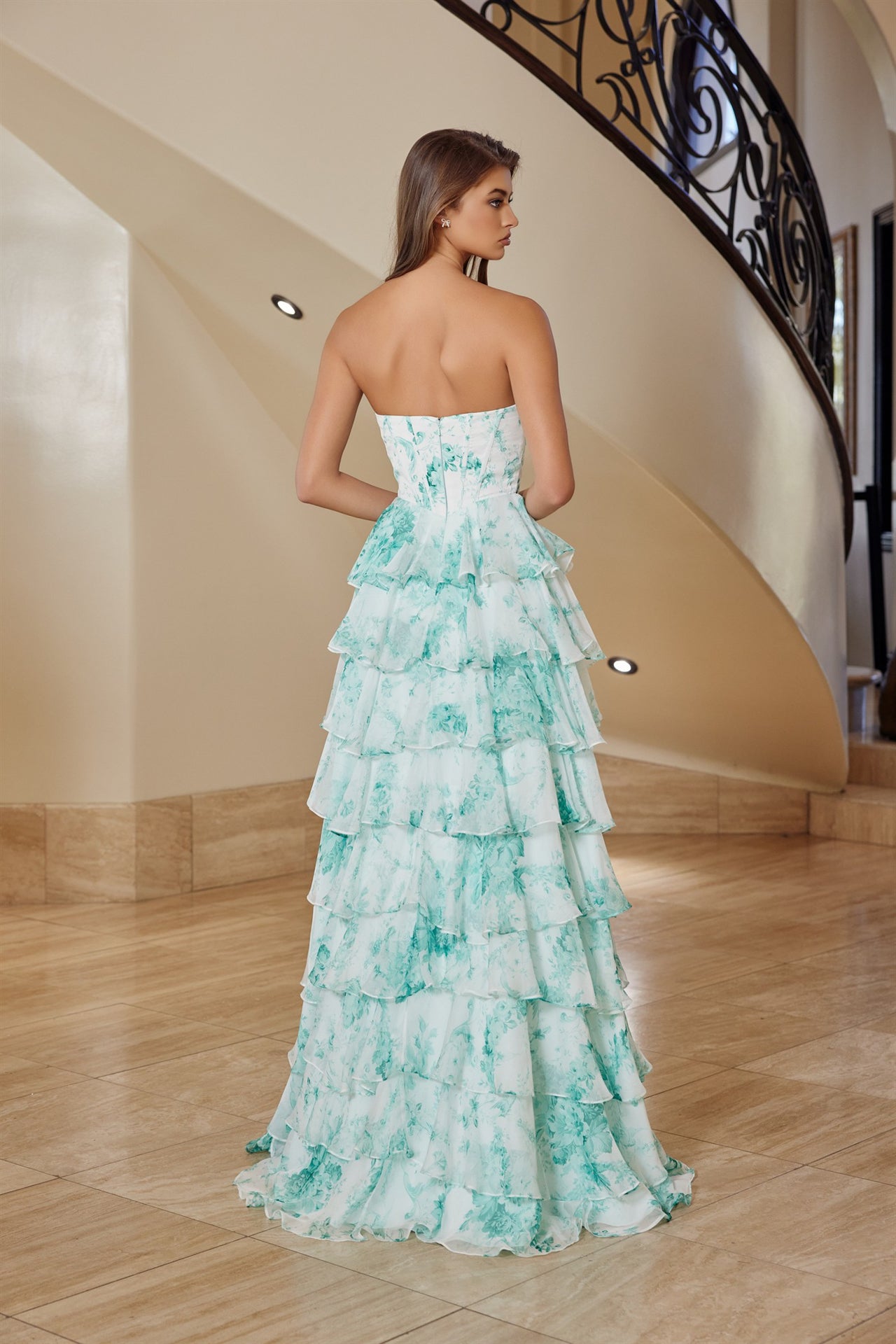Elevate your prom night with the Nox Anabel T1865, a stunning strapless gown designed to turn heads. This dramatic dress features a pleated sweetheart neckline that frames the shoulders beautifully, paired with a structured corset bodice for a flattering silhouette. Cascading ruffles add movement and dimension, while the daring low back and thigh-high slit create an unforgettable look. A sweeping train completes the editorial elegance. Perfect for prom, formal galas, or any black-tie occasion where you want