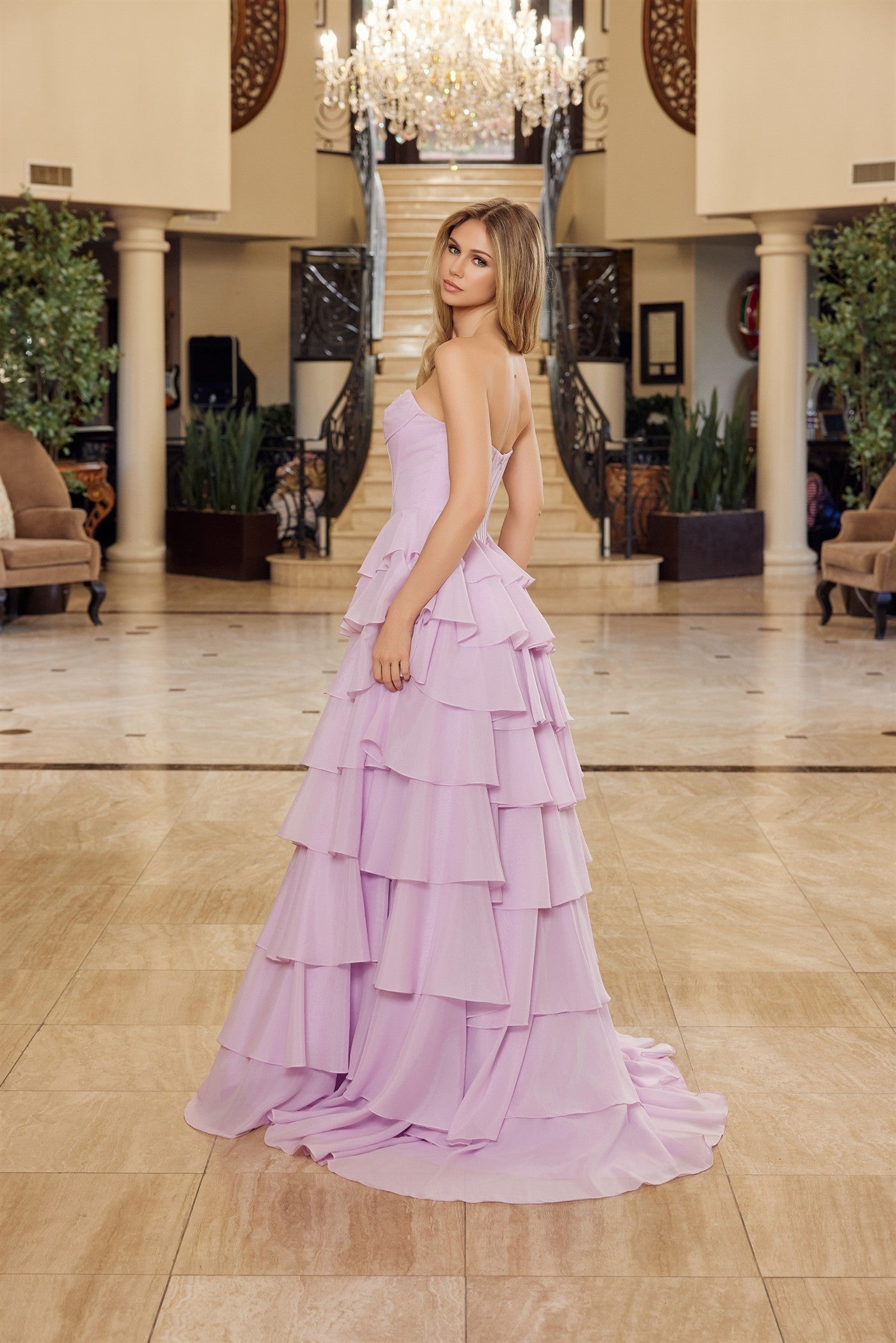 Nox Anabel's Y1806 prom dress combines timeless elegance with modern glamour. The strapless sweetheart neckline frames the shoulders beautifully, while intricate sequin detailing catches light with every movement. A structured corset bodice provides flattering support and definition, flowing into voluminous ruffled layers that create dramatic movement. The low back design adds sophisticated allure, and the sweeping train makes a striking entrance. Perfect for prom, formal galas, or any black-tie occasion wh