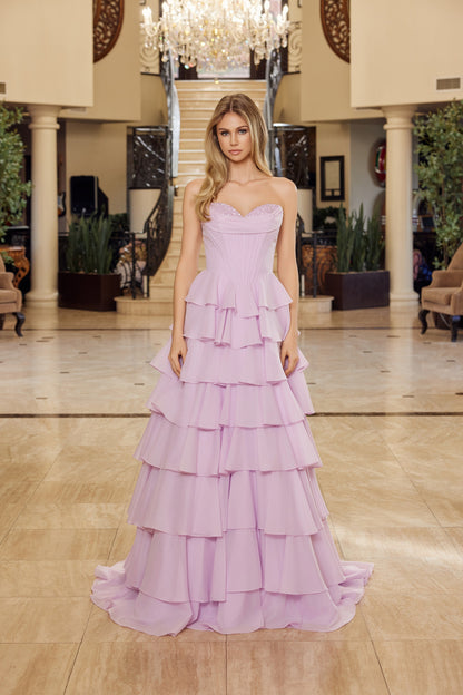 Nox Anabel's Y1806 prom dress combines timeless elegance with modern glamour. The strapless sweetheart neckline frames the shoulders beautifully, while intricate sequin detailing catches light with every movement. A structured corset bodice provides flattering support and definition, flowing into voluminous ruffled layers that create dramatic movement. The low back design adds sophisticated allure, and the sweeping train makes a striking entrance. Perfect for prom, formal galas, or any black-tie occasion wh