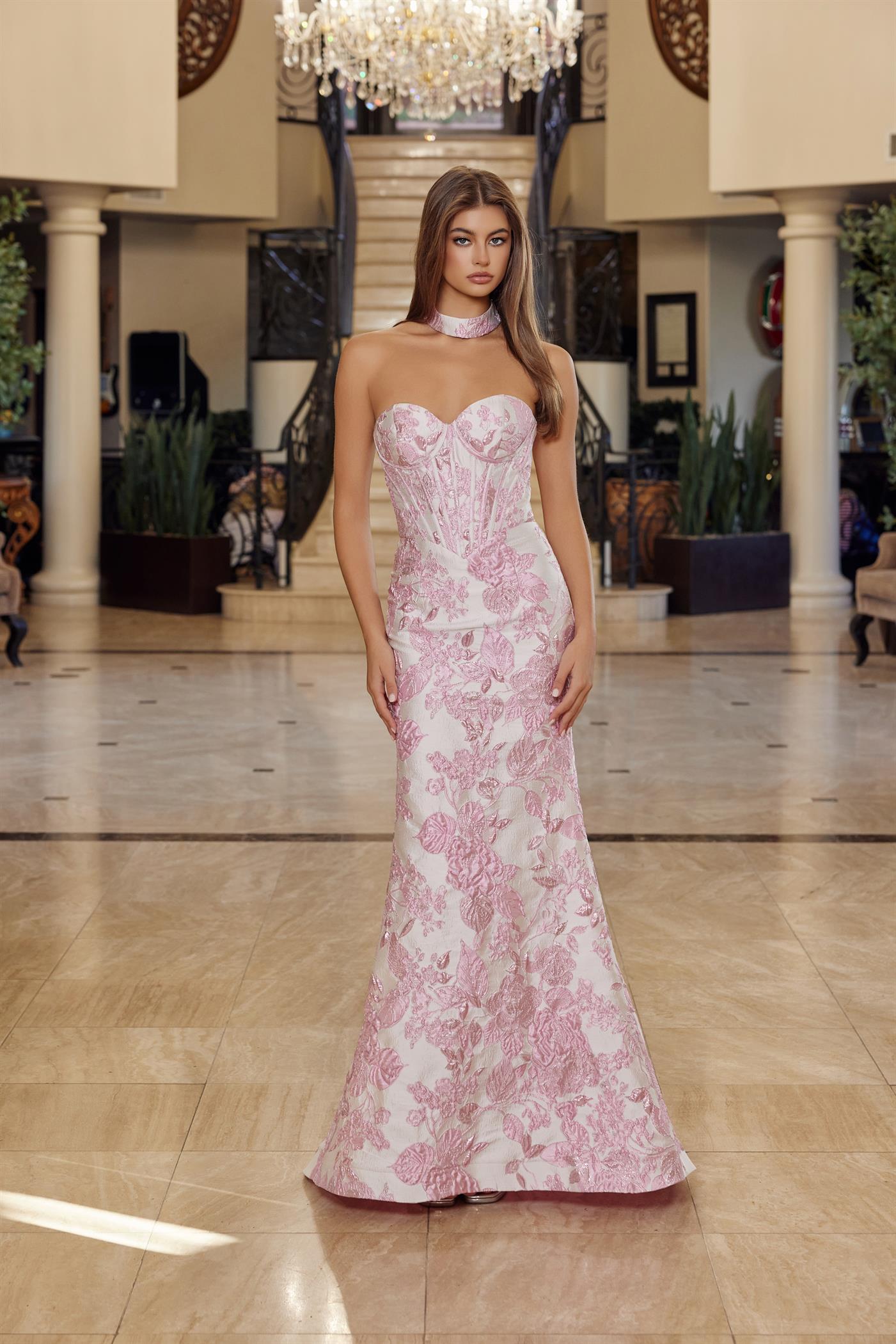 Nox Anabel's T1922 delivers editorial elegance for the modern prom-goer. This strapless sheath silhouette features a structured corset bodice that sculpts and supports, while the dramatic low back and choker train create an unforgettable entrance. The clean lines and refined construction make this dress equally at home on the red carpet or at formal events. A timeless investment piece for those who favor understated luxury and architectural design.

Sizes: 00-16

Colors: Blue, Pink