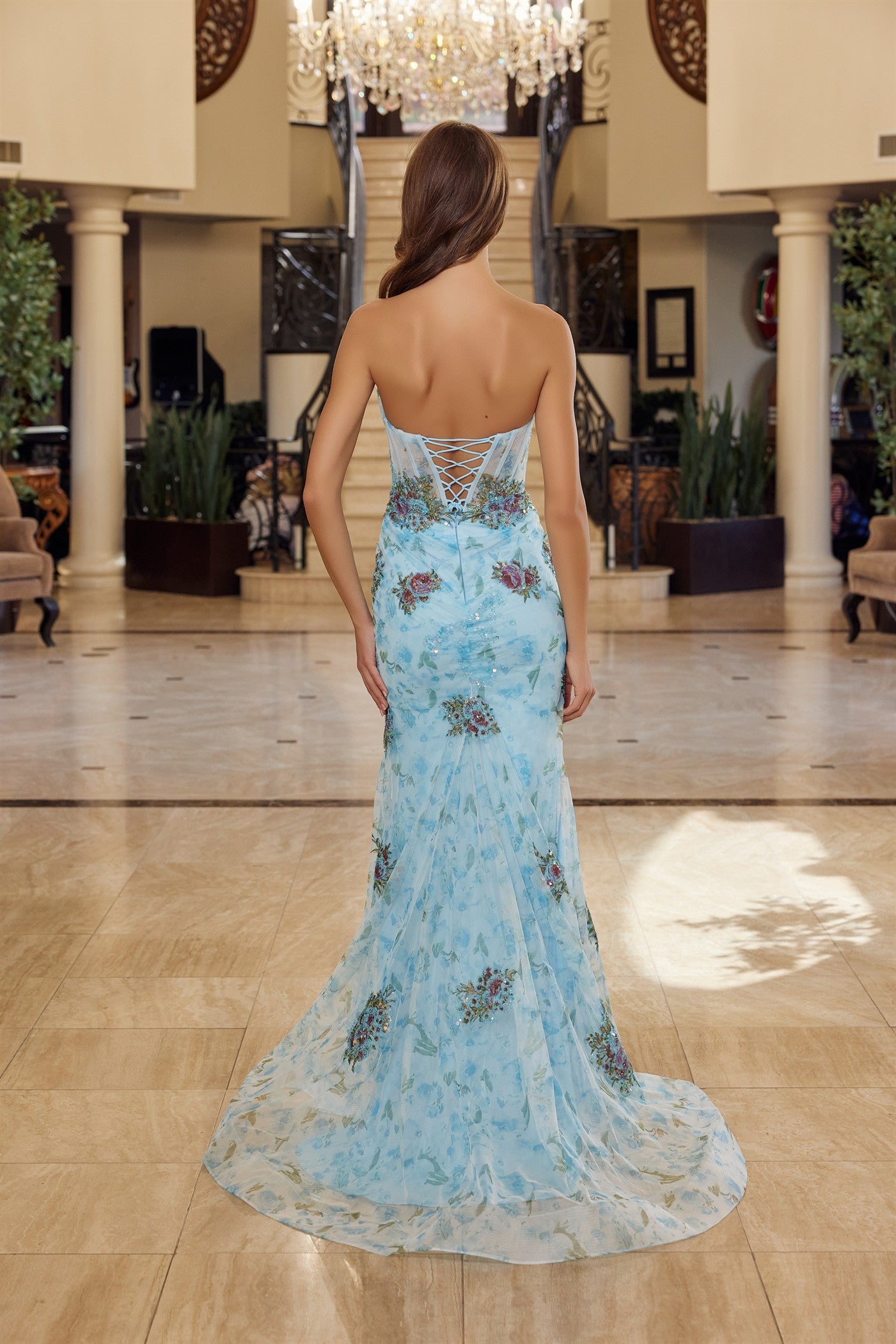 Elevate your prom night with the Nox Anabel Y1801, a stunning strapless gown that commands attention. This exquisite dress features a sheer sequin corset bodice that catches light with every movement, paired with a romantic floral sweetheart neckline. The backless silhouette and graceful train create an unforgettable dramatic effect, perfect for making a grand entrance. Crafted with premium construction and refined details, this gown delivers the luxury and sophistication you deserve for your most important
