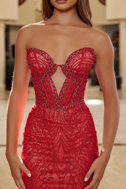 Nox Anabel's C1848 is a show-stopping prom dress designed for those who embrace dramatic elegance. The sweetheart neckline frames the shoulders beautifully, while intricate beading adorns the fitted corset bodice for a refined, structured silhouette. Strategic cutout details add modern sophistication, and the strapless design keeps the focus on the exquisite beadwork. A graceful low back and flowing train complete the look—perfect for making an unforgettable entrance at prom or formal events.

Sizes: 00-16
