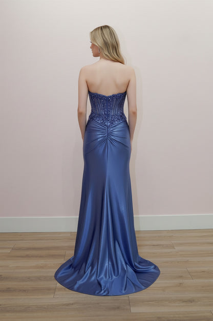 Elevate your prom night with the Nox Anabel E1902, a stunning strapless gown that commands attention. This exquisite dress features a sheer beaded corset bodice that hugs your silhouette with precision, paired with a dramatic slit train that moves with grace. The sweetheart neckline and low back create an alluring, sophisticated look perfect for making an unforgettable entrance. Intricate beadwork catches the light with every step, while the flowing skirt ensures you'll feel like the star of the evening. A 