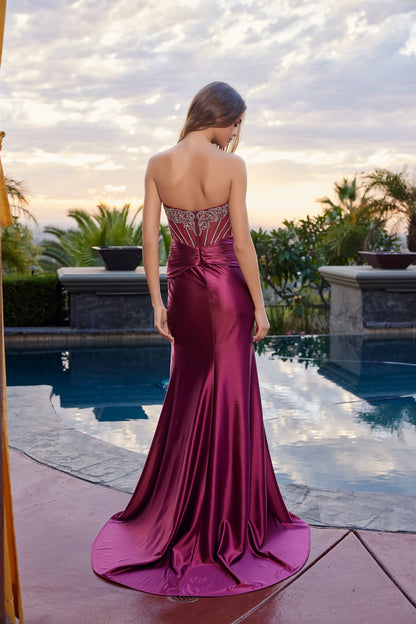 Elevate your prom night with the Nox Anabel L1771, a stunning strapless gown that commands attention. This sophisticated design features a sheer crystal-embellished corset bodice with an elegant scoop neckline, creating a striking balance of glamour and refinement. The dramatic backless silhouette and flowing slit train add movement and allure, perfect for making a memorable entrance. Crafted with premium construction and intricate beading details, this dress delivers the editorial luxury and timeless elega