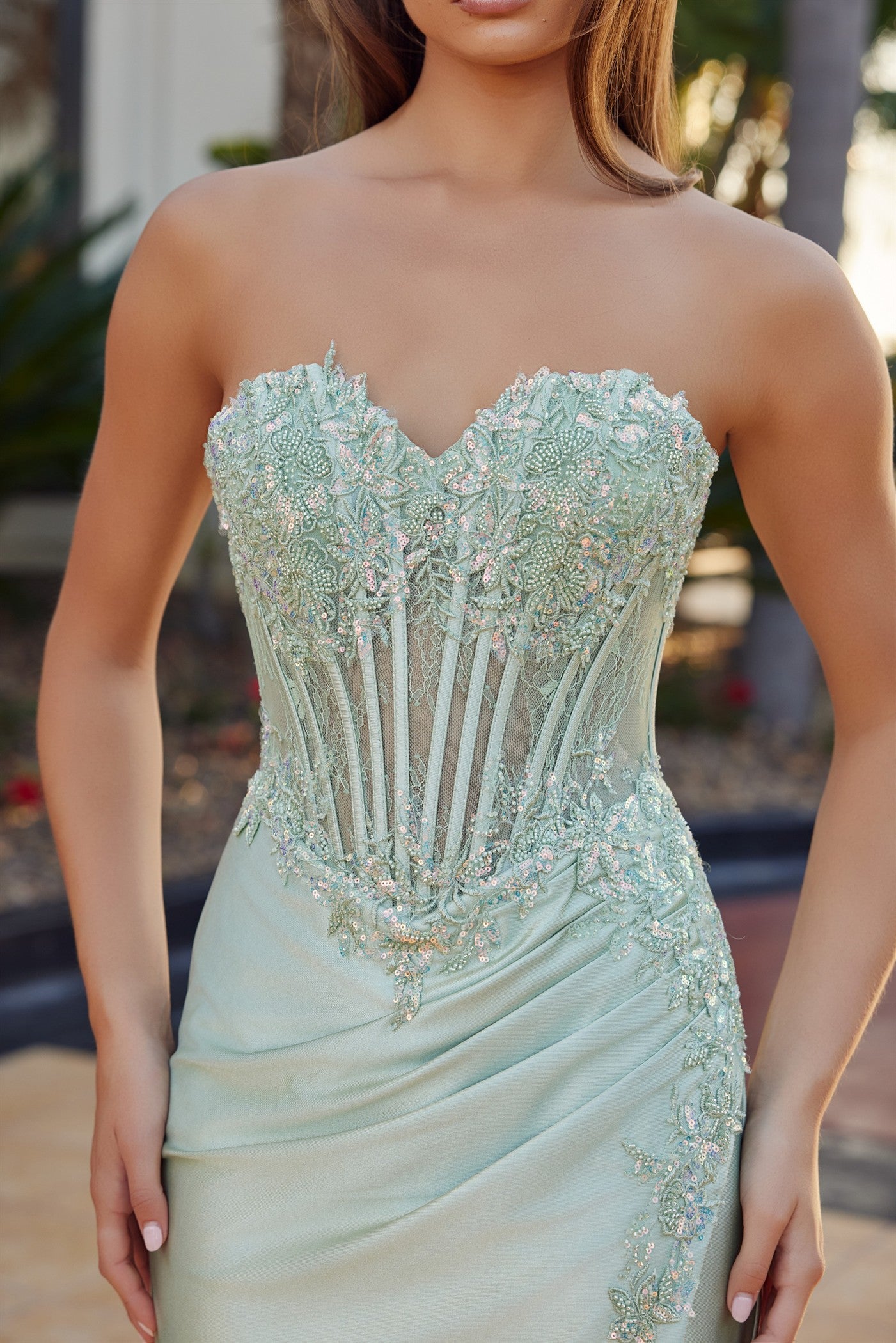 Elevate your prom night with the Nox Anabel R1811, a stunning strapless gown that commands attention. This sheer beaded corset bodice features intricate detailing that catches the light with every movement, while the sweetheart neckline flatters and frames beautifully. The low back design adds modern sophistication, and the dramatic slit train creates an elegant silhouette as you walk. Perfect for those seeking a show-stopping moment on the dance floor.

Sizes: 00-16

Colors: Mocha Gold, Sage Green