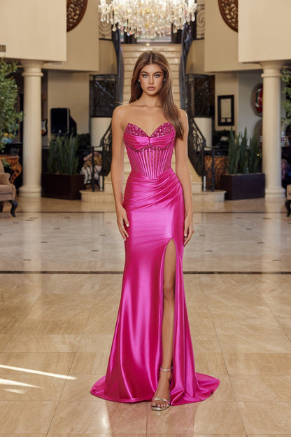 Elevate your prom night with the Nox Anabel R1812, a stunning strapless satin gown that commands attention. This sophisticated design features a sheer crystal-embellished corset bodice with a flattering V-neckline and pleated detailing that creates graceful movement. The luxurious satin skirt flows into a dramatic slit and sweeping train, while the backless silhouette adds an alluring touch of elegance. Perfect for those seeking a show-stopping formal look that balances glamour with refined style.

Sizes: 0