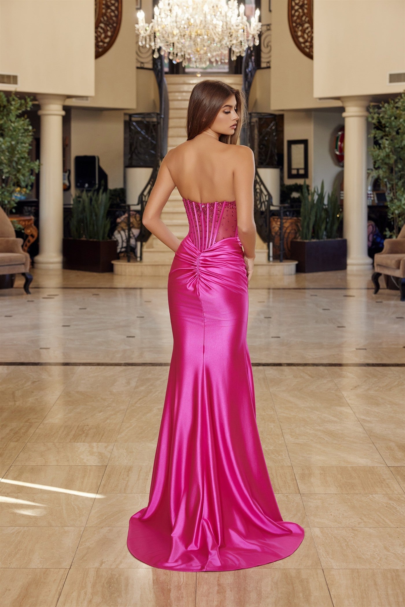 Elevate your prom night with the Nox Anabel R1812, a stunning strapless satin gown that commands attention. This sophisticated design features a sheer crystal-embellished corset bodice with a flattering V-neckline and pleated detailing that creates graceful movement. The luxurious satin skirt flows into a dramatic slit and sweeping train, while the backless silhouette adds an alluring touch of elegance. Perfect for those seeking a show-stopping formal look that balances glamour with refined style.

Sizes: 0