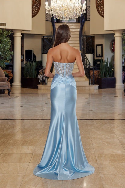 Elevate your prom night with the Nox Anabel R1820, a stunning strapless gown that commands attention. This sophisticated design features a sheer beaded corset bodice that creates an alluring silhouette, paired with luxurious satin fabric for an elegant drape. The scoop neckline and backless cut offer modern glamour, while the dramatic slit train adds movement and sophistication as you walk. Perfect for those seeking a show-stopping formal look that balances sensuality with refined style.

Sizes: 00-16

Colo