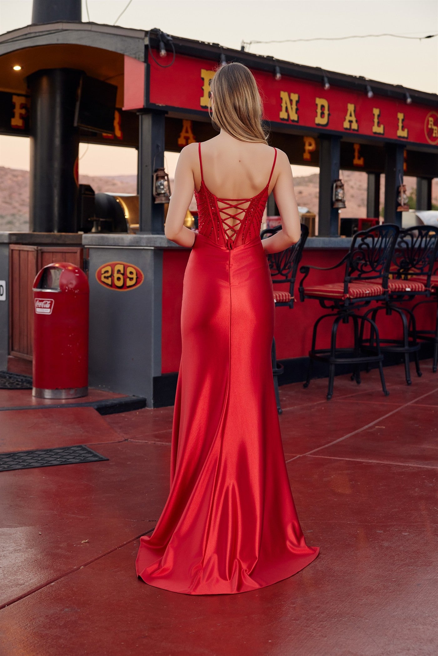 Nox Anabel's S1721 combines timeless elegance with modern glamour. This stunning prom dress features a sheer sequin corset bodice that catches light with every movement, paired with a sweetheart neckline for a romantic silhouette. Delicate spaghetti straps and a daring low back create an unforgettable look, while the flowing skirt with slit train adds movement and sophistication. Perfect for prom, formal events, or any occasion where you want to make a statement.

Sizes: 00-16

Colors: Champagne, Red, Royal