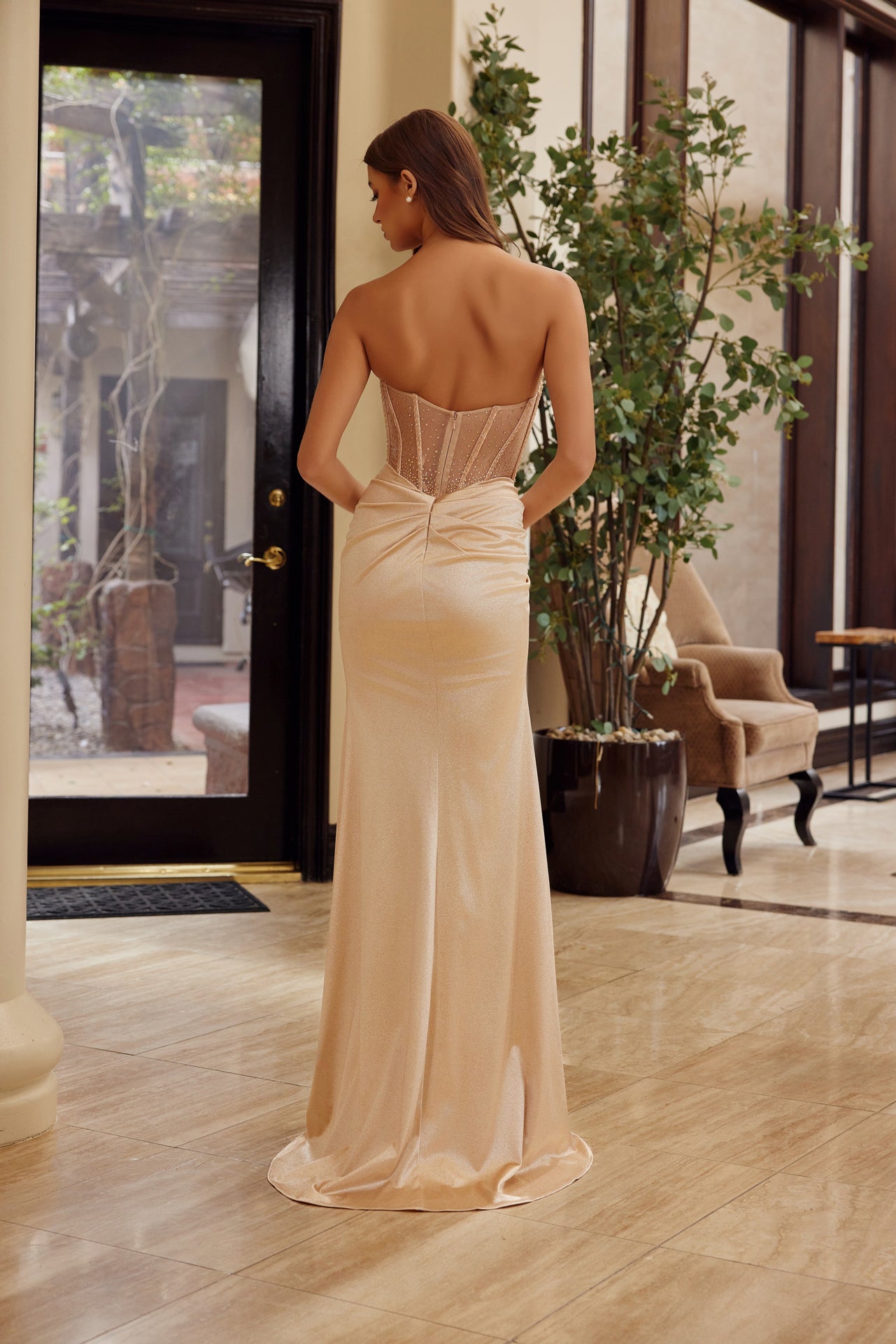 Elevate your prom night with the Nox Anabel A1596, a stunning strapless gown that commands attention. This sophisticated design features a scoop neckline, sheer beaded corset bodice, and luxurious satin fabric that drapes beautifully. The dramatic thigh-high slit and flowing train create movement and elegance, while the backless silhouette adds an alluring touch of modern glamour. Perfect for those seeking a show-stopping formal look that balances classic refinement with contemporary edge.

Sizes: 00-16

Co