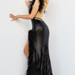 Dazzle everyone in the room with Jovani 06164 Fitted Sequin Prom Dress. This stunning prom dress is the epitome of glamor and sophistication. The floor-length skirt features a train and a high slit trimmed with delicate feathers, adding an ethereal touch to the dress. The sleeveless bodice is adorned with shimmering sequins and features a low V-neckline perfect for showcasing your décolletage. 