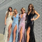 Dazzle everyone in the room with Jovani 06164 Fitted Sequin Prom Dress. This stunning prom dress is the epitome of glamor and sophistication. The floor-length skirt features a train and a high slit trimmed with delicate feathers, adding an ethereal touch to the dress. The sleeveless bodice is adorned with shimmering sequins and features a low V-neckline perfect for showcasing your décolletage. 