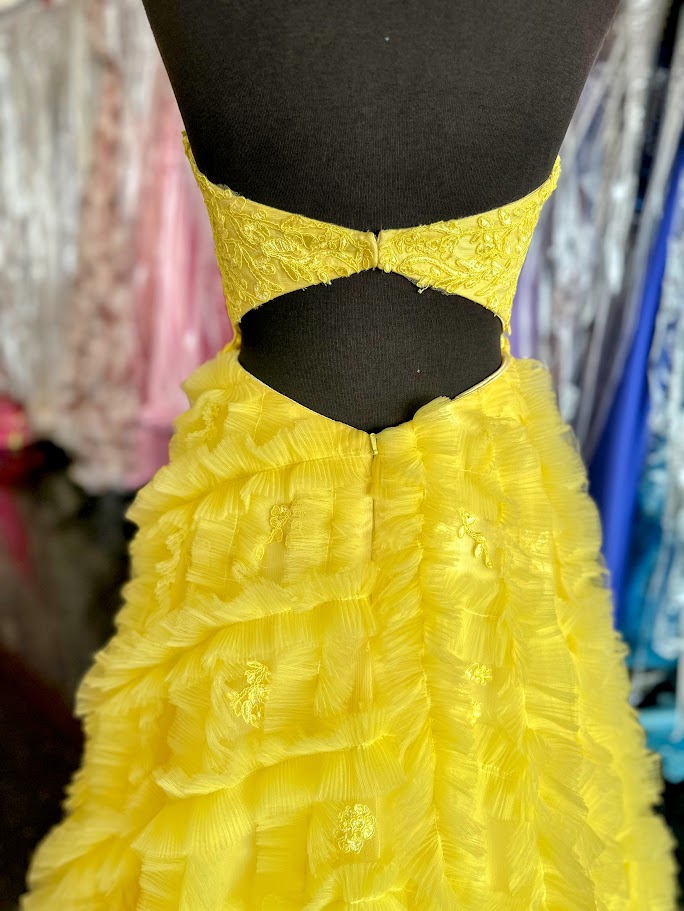 Elevate your formal occasion with this Johnathan Kayne gown, featuring a delicate yellow lace bodice that exudes elegance. The pleated ruffle A-line skirt adds graceful movement, while the cut-out back detail offers a modern, sophisticated touch. Designed in size 4, this ballgown combines classic charm with contemporary style for a stunning, memorable look.

Size: 4

Color: Yellow
