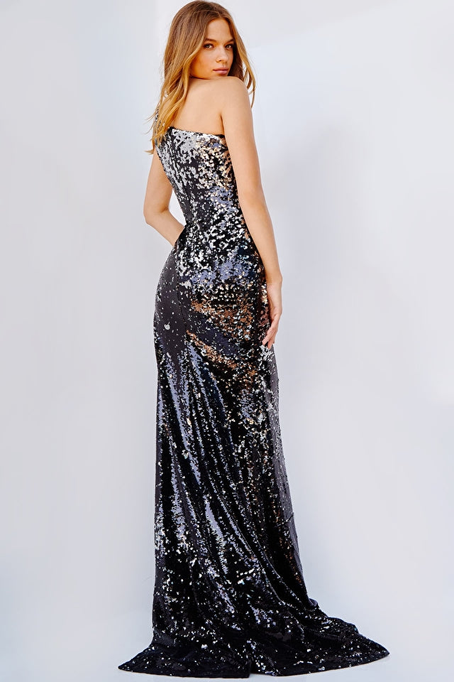 Jovani 09895 Black Fully Reversed Sequin Embellished One Shoulder High Slit Prom Dress. Experience the radiance of Jovani 09895 Black Fully Reversed Sequin Embellished One Shoulder High Slit Prom Dress. Its one-shoulder design is adorned with reversed sequins that sparkle the life of any evening event. Its high slit adds an element of chic sophistication, perfect for any special occasion.