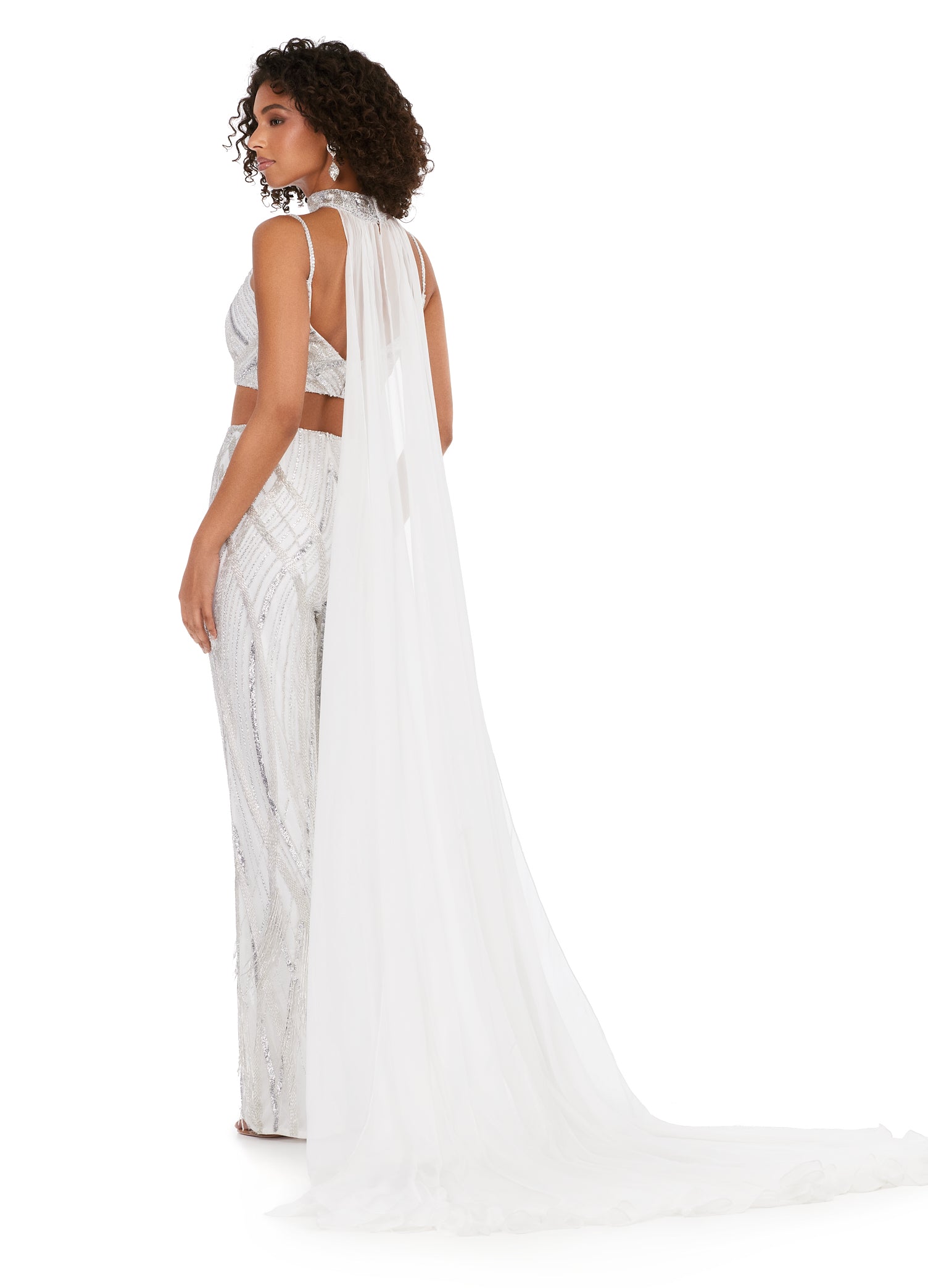 Ashley Lauren 11385 Fully Beaded 2-Piece With Chiffon Cape Spaghetti Strap Jumpsuit. Bring on the drama in this jumpsuit. The bustier and pants are adorned with an intricate bead pattern. The bead pattern continues along the chocker. The choker is complete with a long chiffon cape.