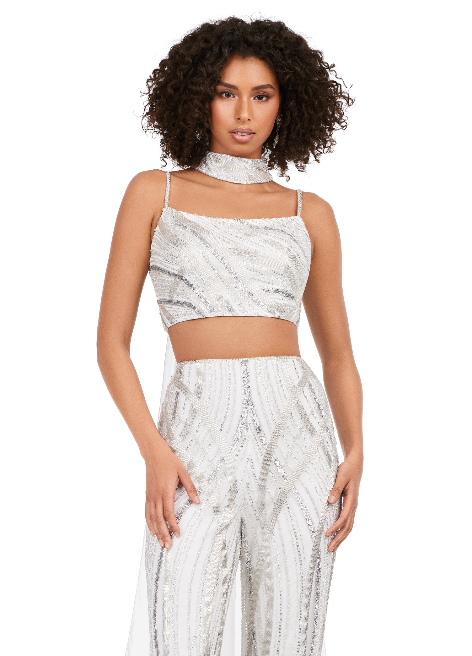 Ashley Lauren 11385 Fully Beaded 2-Piece With Chiffon Cape Spaghetti Strap Jumpsuit. Bring on the drama in this jumpsuit. The bustier and pants are adorned with an intricate bead pattern. The bead pattern continues along the chocker. The choker is complete with a long chiffon cape.
