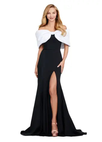 Expertly designed for a flawless evening, the Ashley Lauren 11412 Long Prom Dress boasts an off-shoulder cut, scuba fabric, and an elegant oversized bow. Make an unforgettable statement at your next formal event with this stunning pageant gown. Make a statement in this elegant gown. The off shoulder bustier is complete with an oversized bow and the skirt has a left leg slit. dress that's paired with an oversized bow and leg opening.