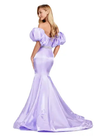 Expertly crafted by Ashley Lauren, this 11419 Long Prom Dress boasts a stunning mermaid silhouette with a strapless design and luxurious satin fabric. The oversized puff sleeves add a bold and elegant touch, making you stand out at any formal event or pageant. Elevate your look with this timeless and sophisticated gown.  Voluminous puff sleeves and a classic sweetheart neckline frame this stunning gown. With its mermaid fit and jeweled belt, this gown is a dream come true!
