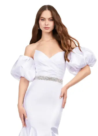 Expertly crafted by Ashley Lauren, this 11419 Long Prom Dress boasts a stunning mermaid silhouette with a strapless design and luxurious satin fabric. The oversized puff sleeves add a bold and elegant touch, making you stand out at any formal event or pageant. Elevate your look with this timeless and sophisticated gown.  Voluminous puff sleeves and a classic sweetheart neckline frame this stunning gown. With its mermaid fit and jeweled belt, this gown is a dream come true!