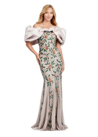 The Ashley Lauren 11433 long prom dress features a beaded off shoulder design and oversized ruffle detailing, making it the perfect formal pageant gown. Its elegant and figure-hugging silhouette is sure to make you stand out among the crowd. Channel your inner pageant queen and capture everyone's attention with this stunning dress. A fully beaded gown sure to steal the show. This gown features an oversized off shoulder taffeta ruffle taking this look to the next level.