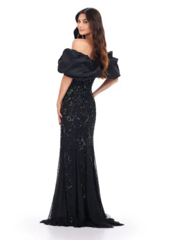 The Ashley Lauren 11433 long prom dress features a beaded off shoulder design and oversized ruffle detailing, making it the perfect formal pageant gown. Its elegant and figure-hugging silhouette is sure to make you stand out among the crowd. Channel your inner pageant queen and capture everyone's attention with this stunning dress. A fully beaded gown sure to steal the show. This gown features an oversized off shoulder taffeta ruffle taking this look to the next level.