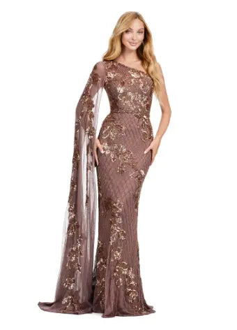 The Ashley Lauren 11434 Long Prom Dress is the epitome of elegance and sophistication. With a one shoulder design, fully beaded gown, and floor length silhouette, this dress will make you feel like a star on any special occasion. The sleeve adds a touch of formality, perfect for pageants or formal events. A twist on a classic. This gorgeous fully beaded gown features a one shoulder floor length sleeve for the perfect touch of drama.  Sizes Available: 0,2,4,6,8,10,12,14,16,18,20,22,24