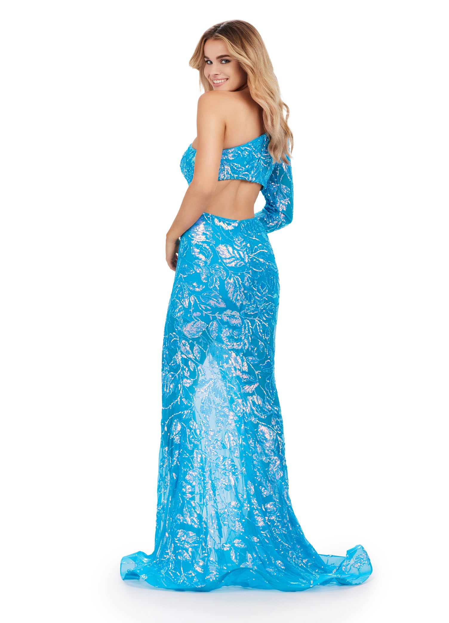 The Ashley Lauren 11442 Prom Dress is an elegant and stylish option for your next formal event. This dress features long sleeves and a one shoulder design, adorned with sparkling sequins for a touch of glamour. The sheer slit and cut out back add a modern twist, making this dress a standout choice. Shine bright in this fully sequin one shoulder gown! Perfect for any occasion, this elegant gown features a left leg slit and cut out back!
