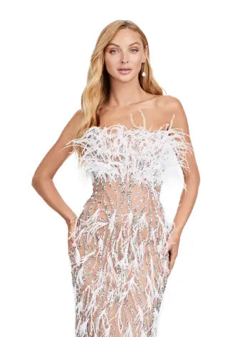 This Ashley Lauren long prom dress features a strapless, fully beaded bodice and a stunning feathered skirt, making it the perfect choice for any formal pageant. The intricate detailing and elegant design truly make this gown stand out and ensure you'll make a statement at any event. We're here for this look! This fully beaded strapless gown features an intricate beaded design and feathers throughout to help you stand out at your next event.