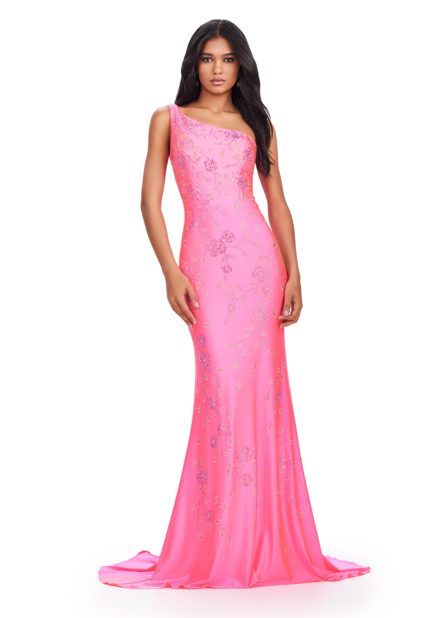 Make a stunning entrance in the Ashely Lauren 11525 Long Prom Dress. Featuring a one shoulder design and a press on floral bead pattern, this gown exudes sophistication and elegance. The jersey fabric offers a comfortable and flattering fit, perfect for any formal occasion. Make a statement in this pageant-worthy gown. This one shoulder jersey gown features a delicate multi-colored heat set stone floral bead pattern that cascades down onto the skirt.